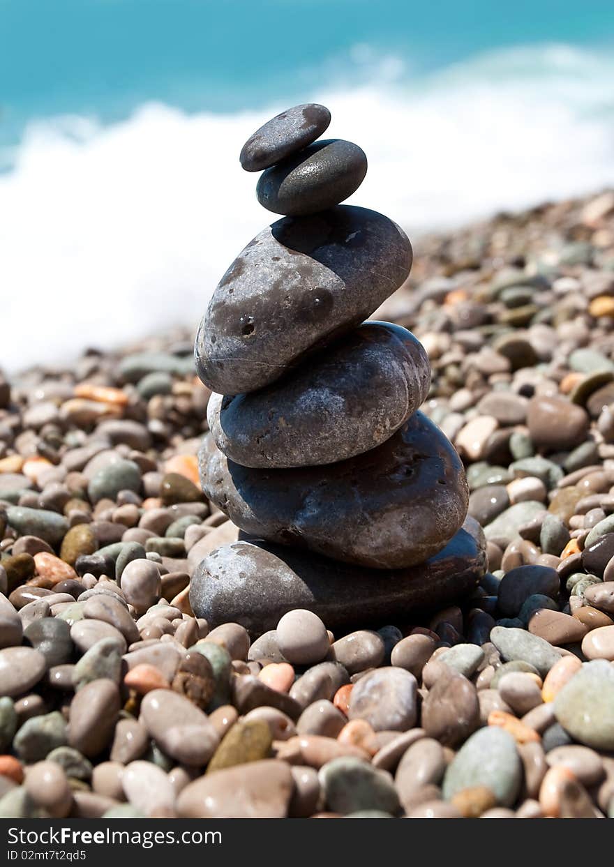 Pile of pebble stones over blue sea