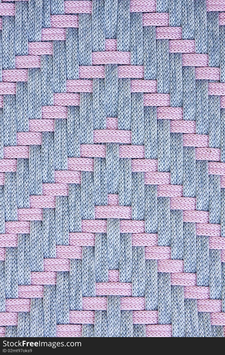 Pink and grey fabric strands in arrow weave pattern