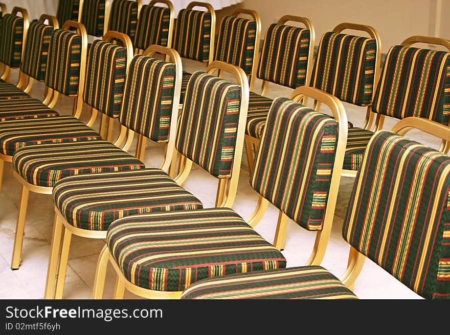 Golden chairs in coference room.