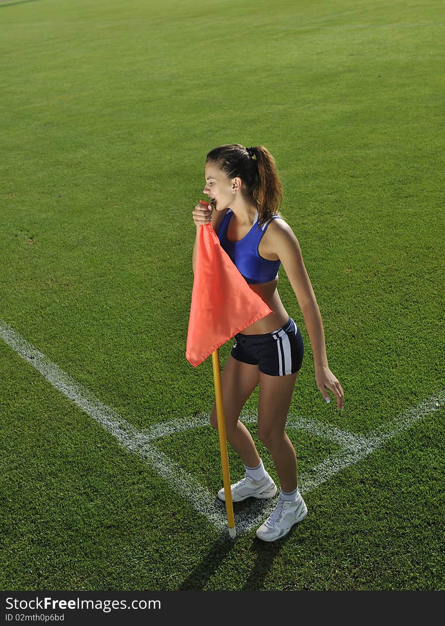 Young woman on corner of soccer stadium