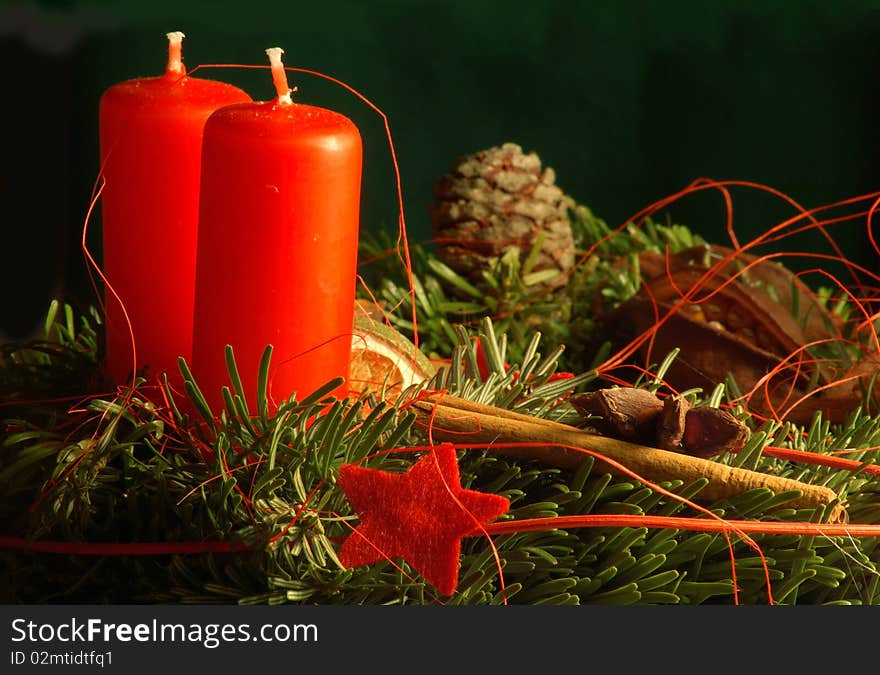 Two red candles and advent wreath with stars and cinnamon. Two red candles and advent wreath with stars and cinnamon