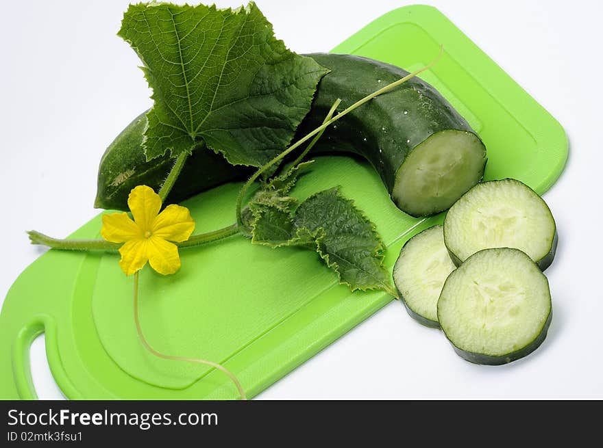 Green cucumber with flower and leaf on the white background