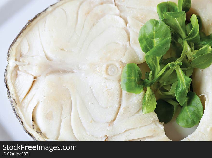 Steak white fish on a plate with salad