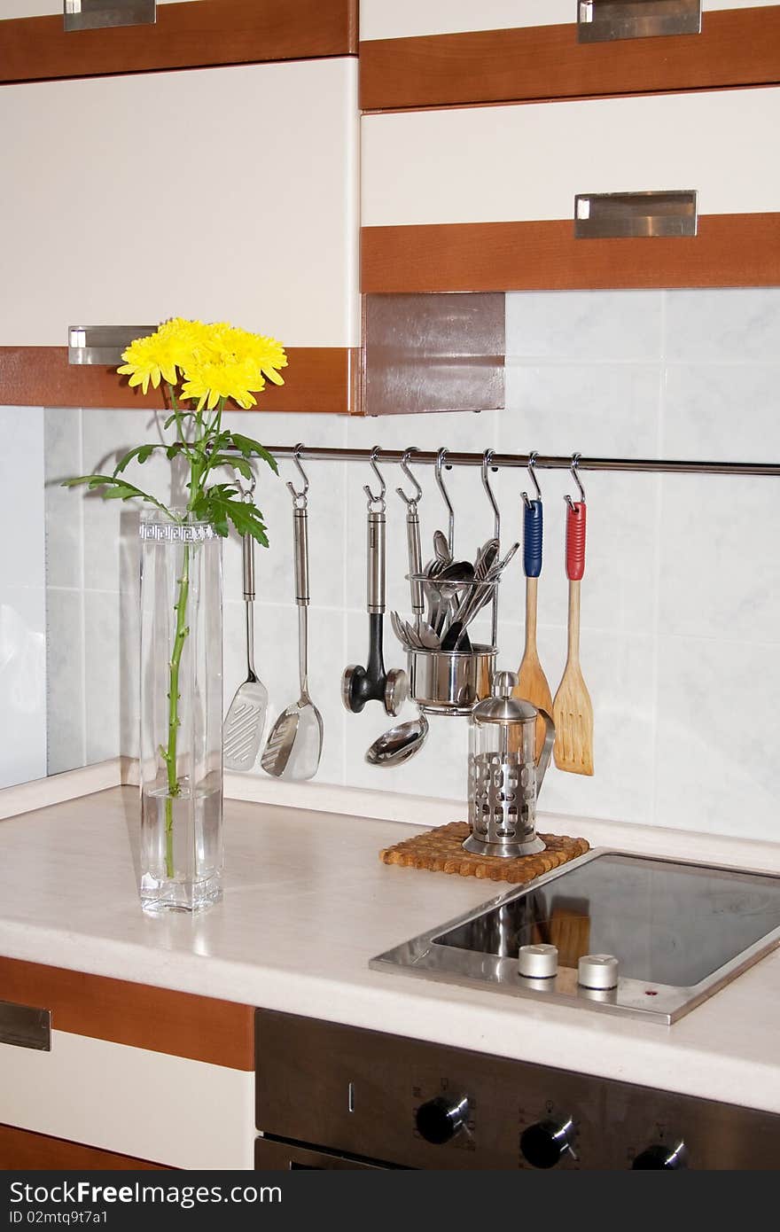 Vase with yellow chrysanthemums on kitchen. A fragment of an interior of kitchen