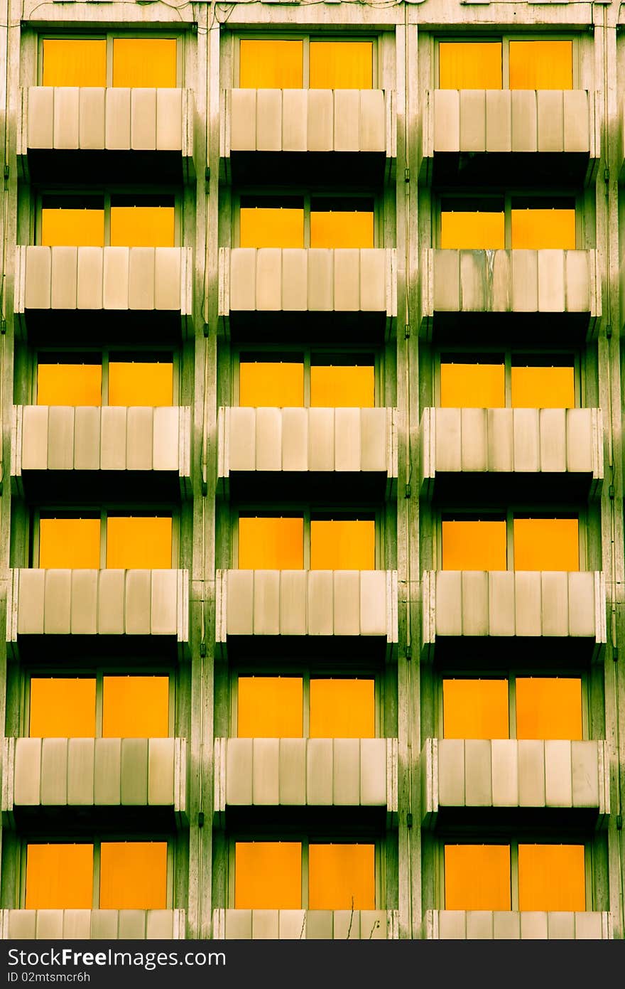 Symetrycal features of a building with yellow windows. Symetrycal features of a building with yellow windows.