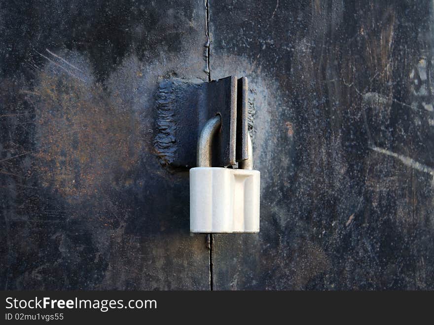 The iron door is closed on a padlock