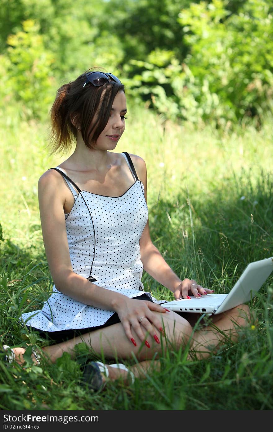 Girl with a notebook sit on the glade. Girl with a notebook sit on the glade