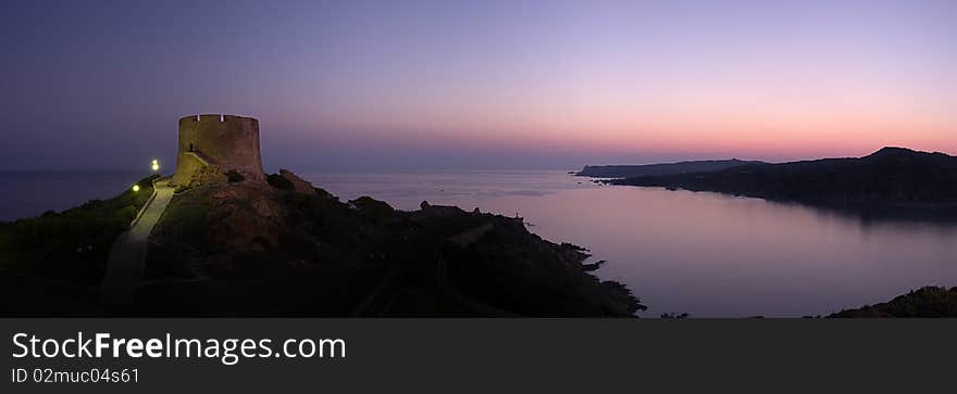 Panoramic view at dawn of coastline whit old ruins of spanish tower in Saint Teresa of Gallura Sardinia Italy copy space. Panoramic view at dawn of coastline whit old ruins of spanish tower in Saint Teresa of Gallura Sardinia Italy copy space