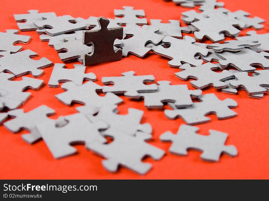 Lonely black puzzle around of crowd grey puzzle. Lonely black puzzle around of crowd grey puzzle