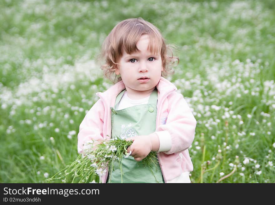 Little beautiful girl with bunch of flowers