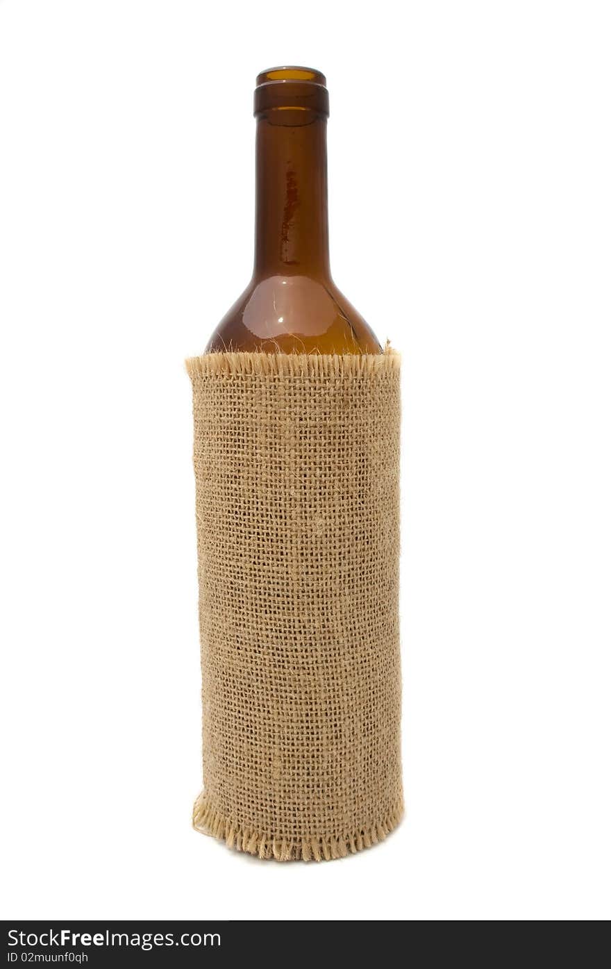 An open wine bottle on sackcloth isolated on a white background. An open wine bottle on sackcloth isolated on a white background