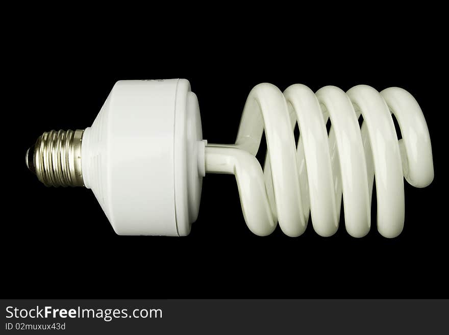 Energy saving lightbulb on black background, cutout, with clipping path. Energy saving lightbulb on black background, cutout, with clipping path