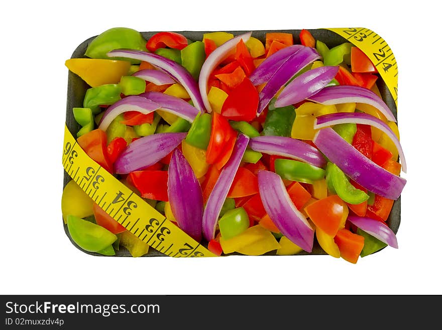 Cut vegetables with measuring tape on white background with clipping path. Cut vegetables with measuring tape on white background with clipping path