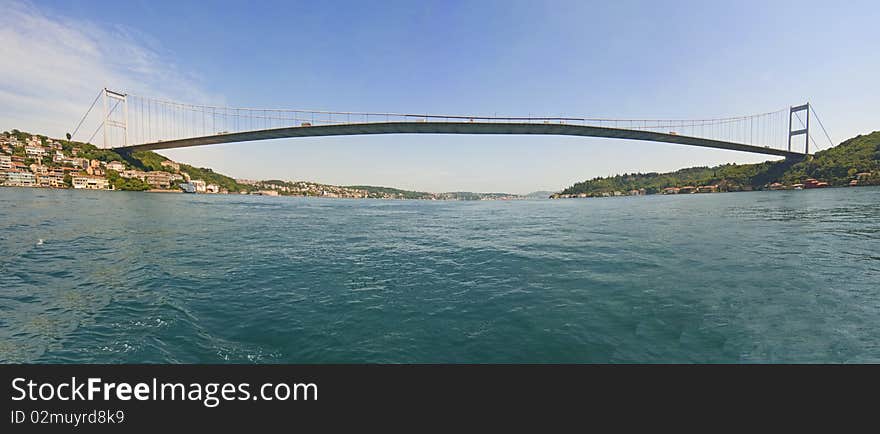 Ataturk suspension bridge spanning the Bosphorus river in Istanbul, Turkey against a blue sky. Ataturk suspension bridge spanning the Bosphorus river in Istanbul, Turkey against a blue sky