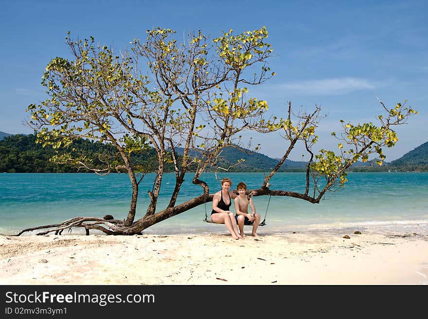 Mother And Son Sitting On A Beautiful Swing