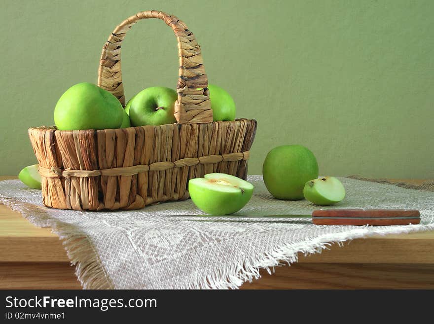 Green apples in the basket with knife. Green apples in the basket with knife