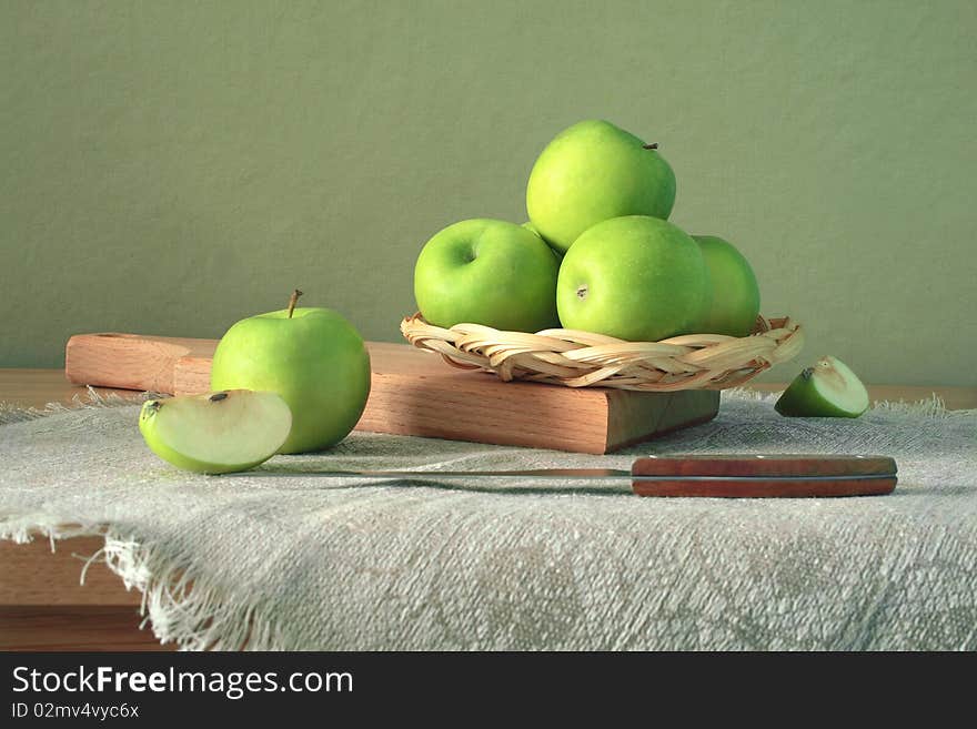 Green apples in the twist with knife. Green apples in the twist with knife