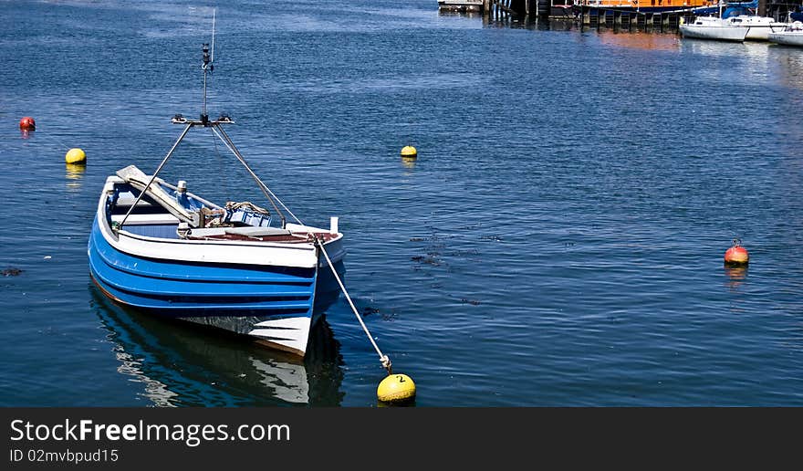 A small blue boat in Whitby harbour.