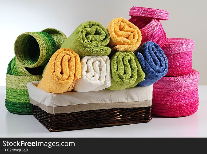 Rolled up colorful towels in straw basket. Rolled up colorful towels in straw basket