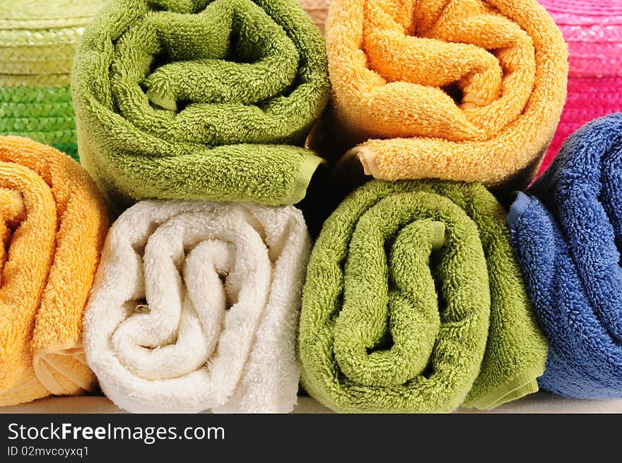 Rolled up colorful towels in straw basket. Rolled up colorful towels in straw basket