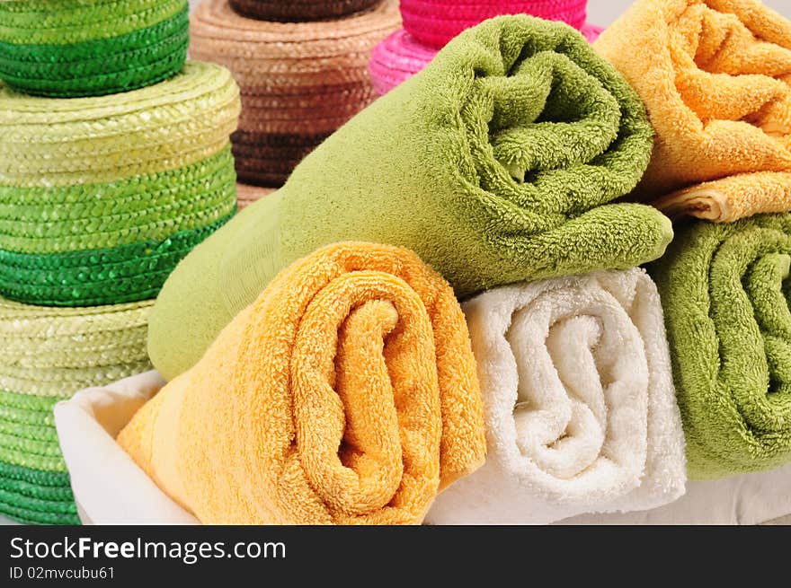 Rolled up colorful towels in straw basket. Rolled up colorful towels in straw basket