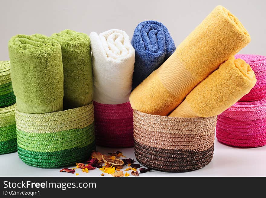 Rolled up colorful towels in straw basket. Rolled up colorful towels in straw basket