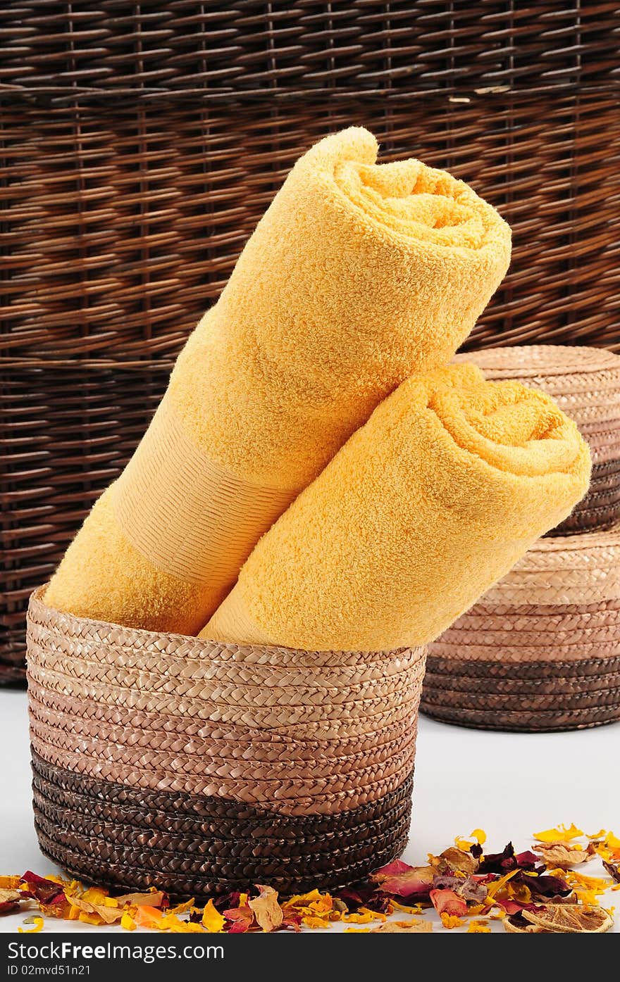 Rolled up colorful towels in straw basket. Rolled up colorful towels in straw basket