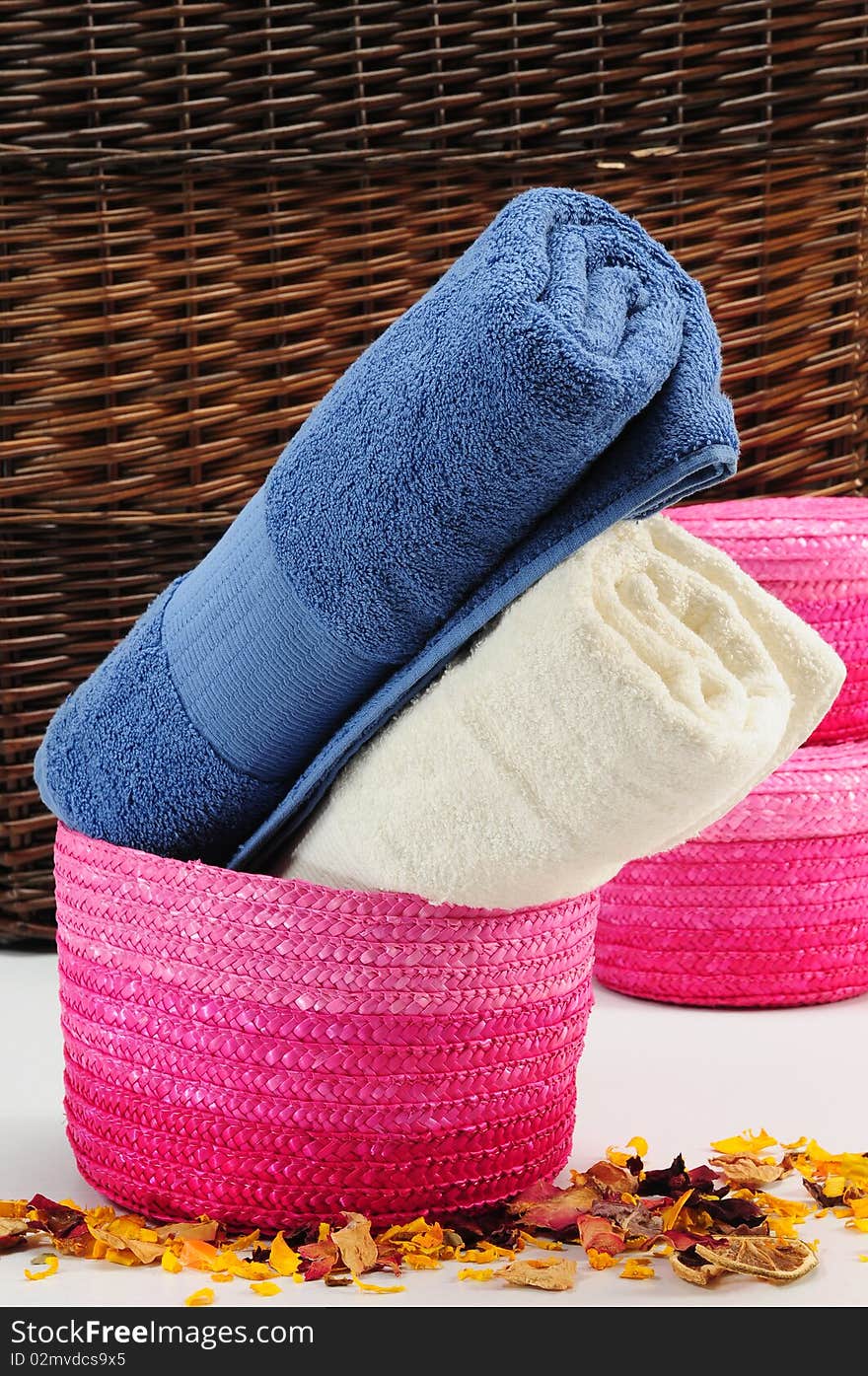 Rolled up colorful towels in straw basket. Rolled up colorful towels in straw basket