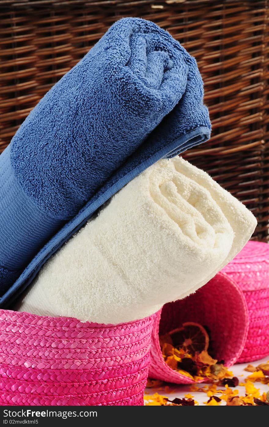 Rolled up colorful towels in straw basket. Rolled up colorful towels in straw basket