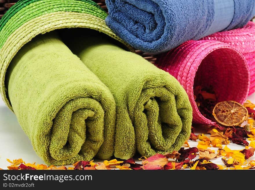 Rolled up colorful towels in straw basket. Rolled up colorful towels in straw basket