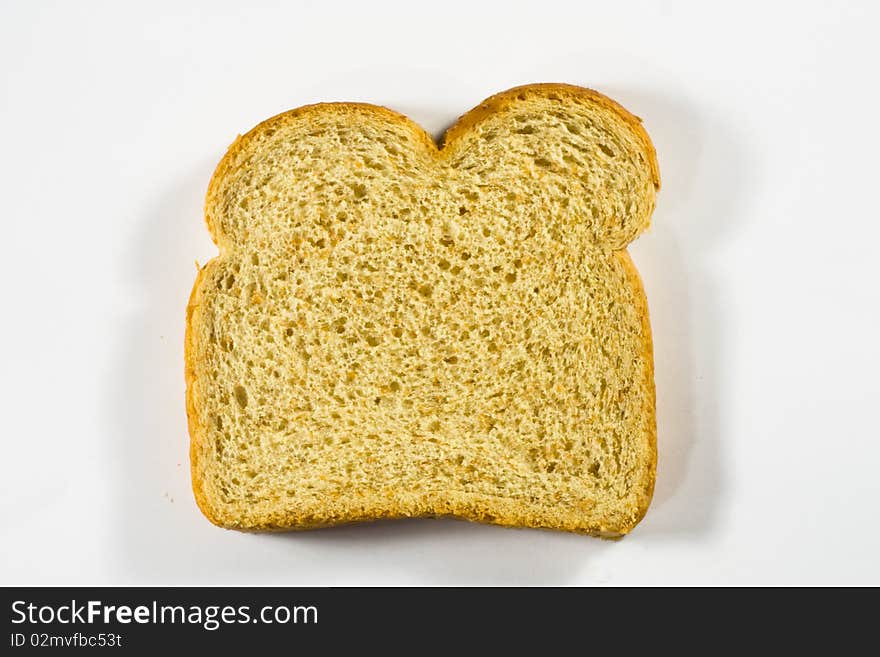 A slice of wheat bread against a white background. A slice of wheat bread against a white background