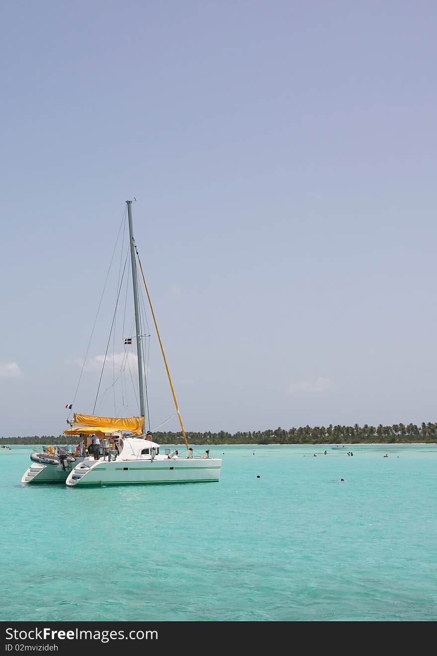 Catamaran and people swimming in Caribbean sea. Catamaran and people swimming in Caribbean sea