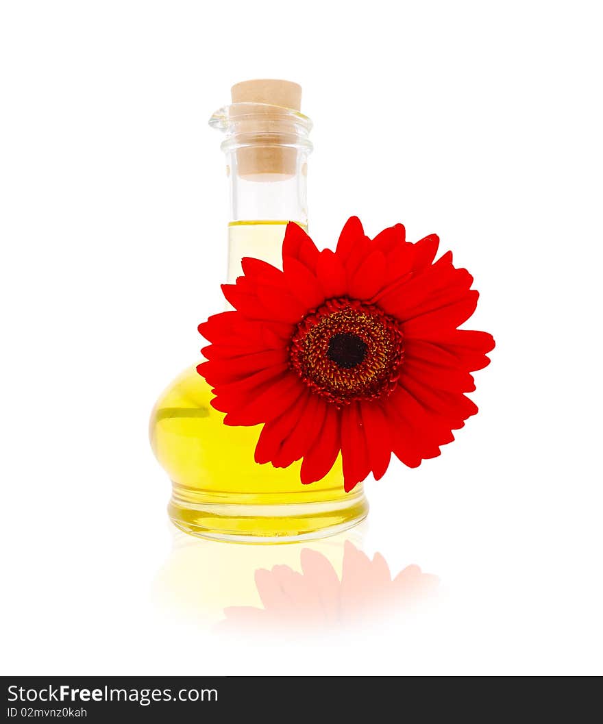 Jug with vegetable oil with a red gerbera