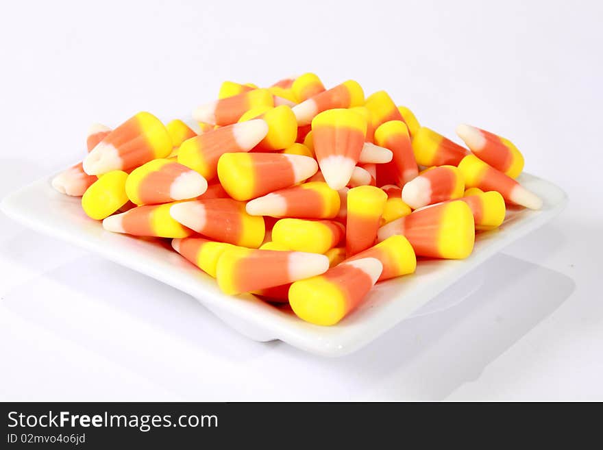 White, yellow and orange candy corn in a bowl