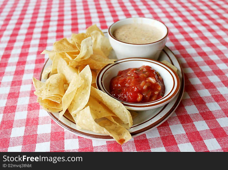 Chips, queso and salsa on table. Chips, queso and salsa on table