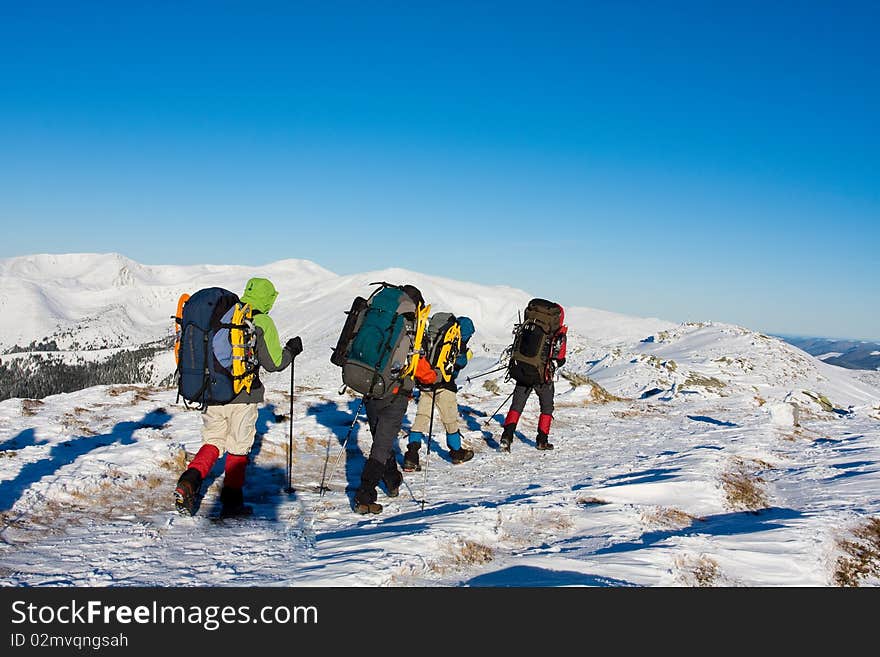 Hiker in winter in mountains