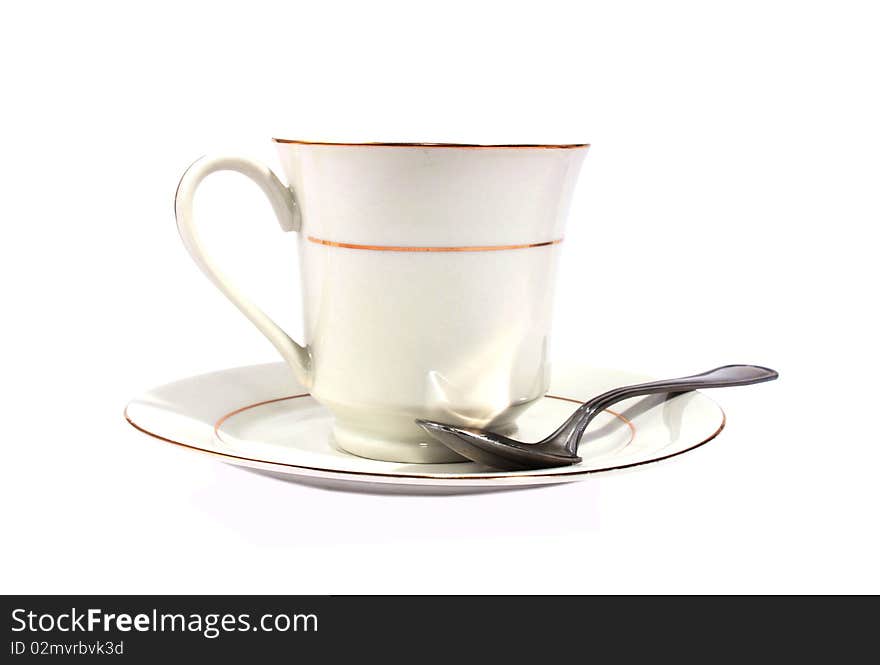 White cup with saucer and spoon