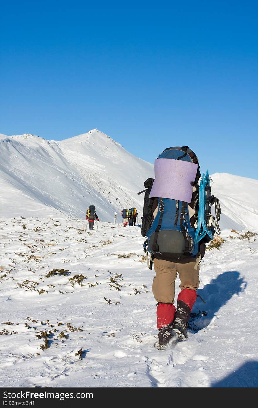 Hiker in winter in mountains