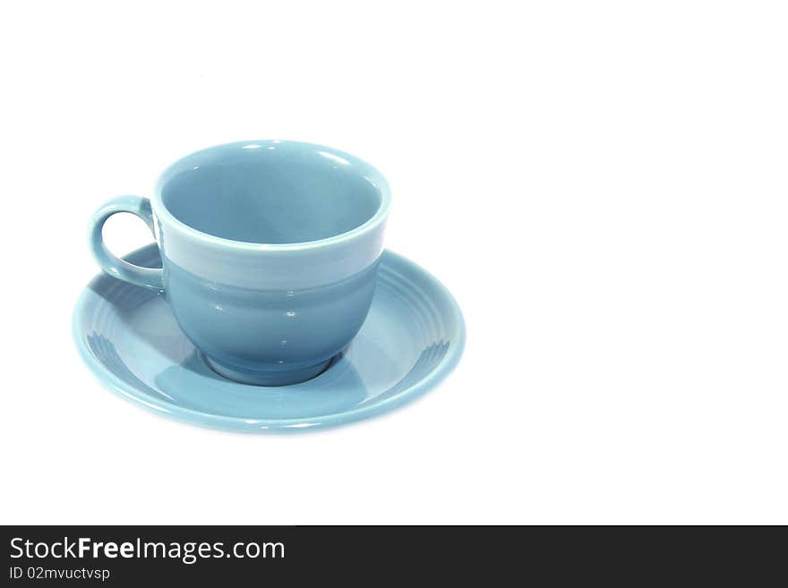 Light blue cup with saucer on white