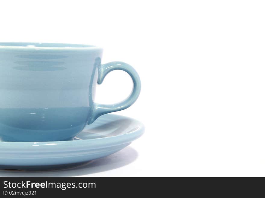 Light blue cup with saucer on white