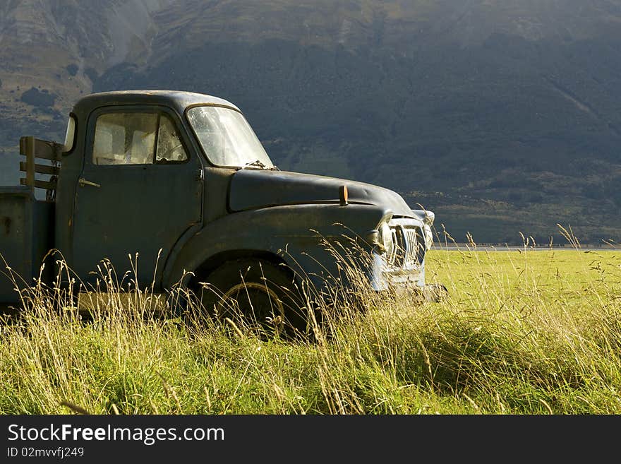 An old pickup truck in a grassy field. An old pickup truck in a grassy field