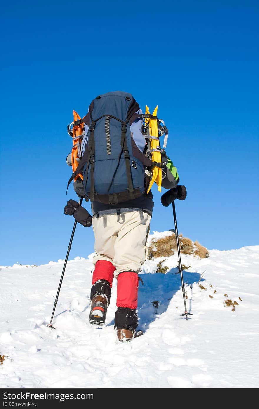 Hiker in winter in mountains