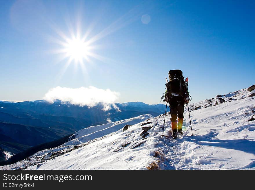 Hiker in winter in mountains