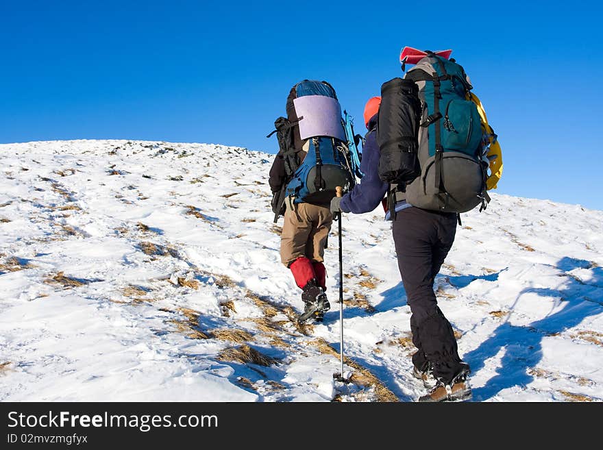 Hiker in winter in mountains