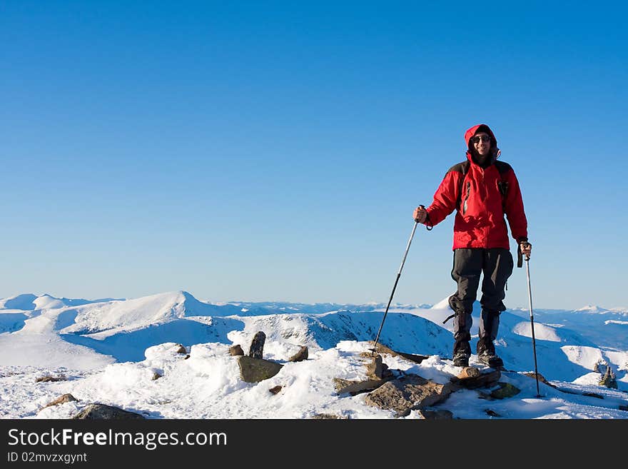 Hiker in winter in mountains