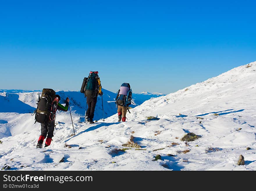 Hiker in winter in mountains