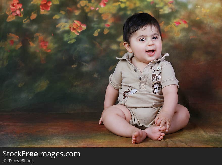 A cute chubby baby sitting pretty and smiling. A cute chubby baby sitting pretty and smiling.