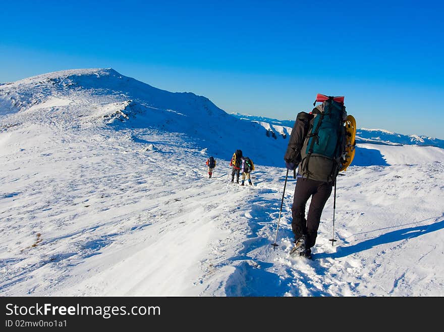 Hiker in winter in mountains