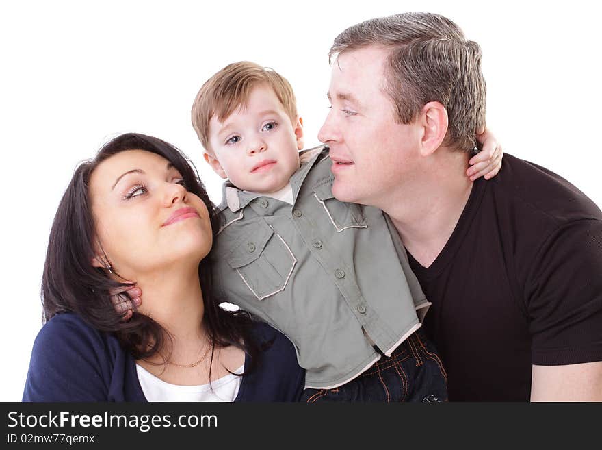 Joyful family. Father, mother look at boy. Isolated on white background. Joyful family. Father, mother look at boy. Isolated on white background