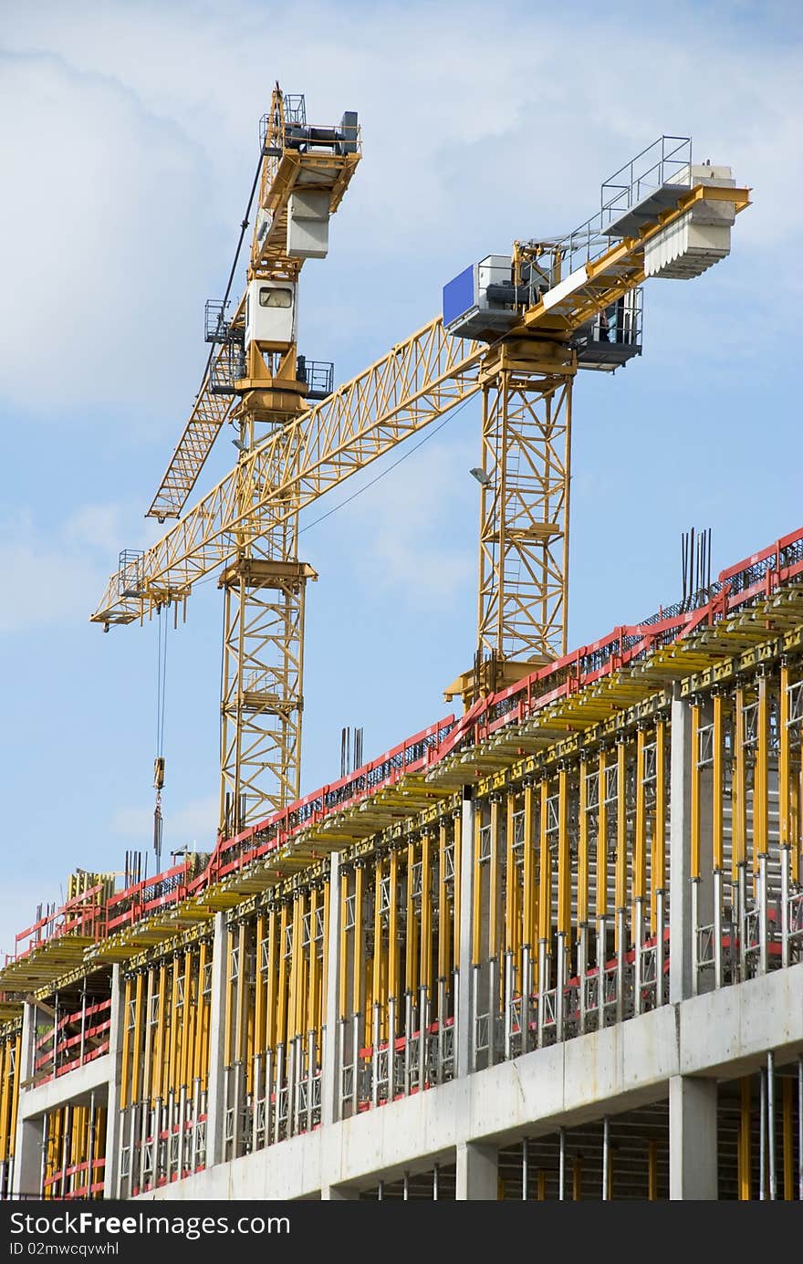 Two yellow crane working blue